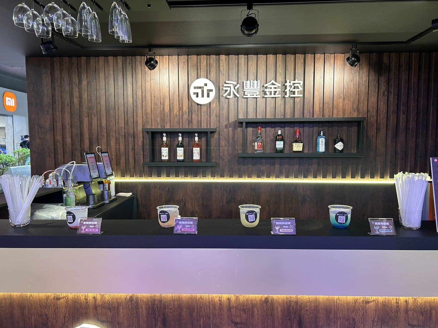 SinoPac Holdings pop-up bar — wooden counter with branded menu and the machine