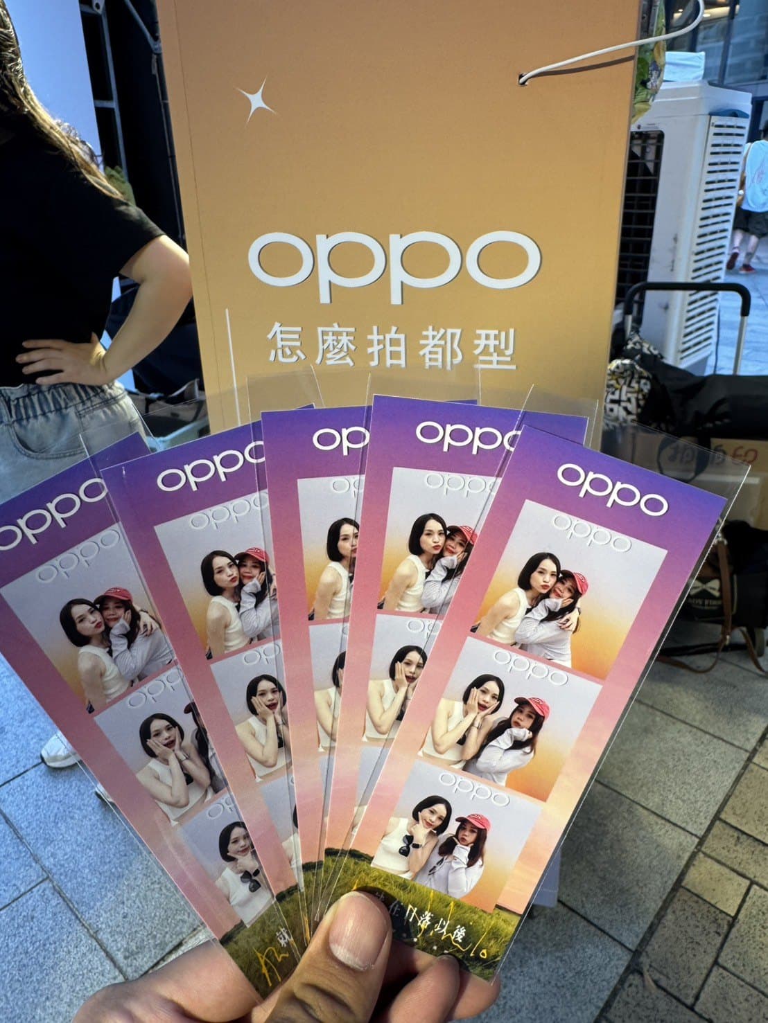 OPPO pop-up: four branded photo strips fresh off the printer