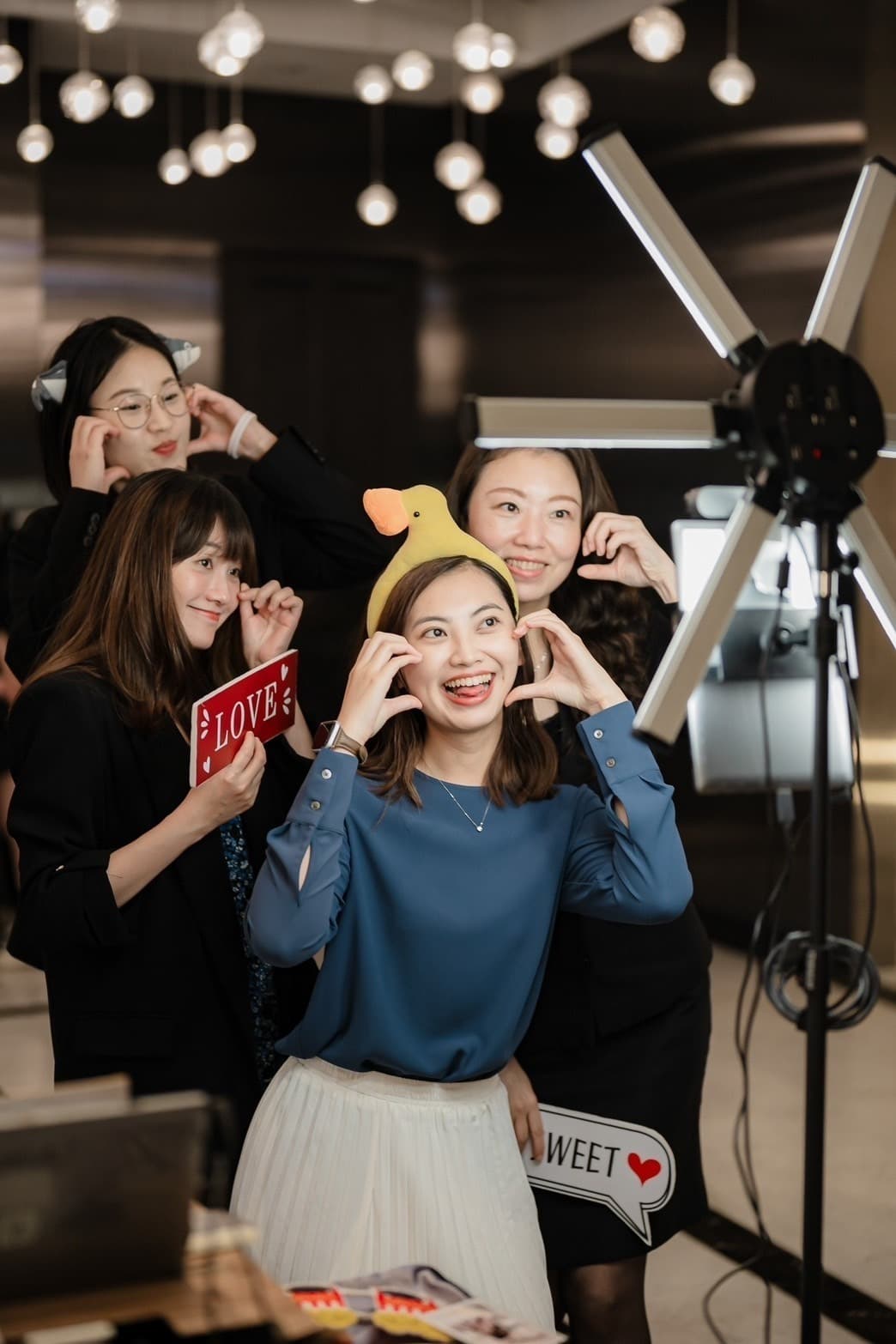 Guests in formal dress at the photo station, the six-point star light visible at right