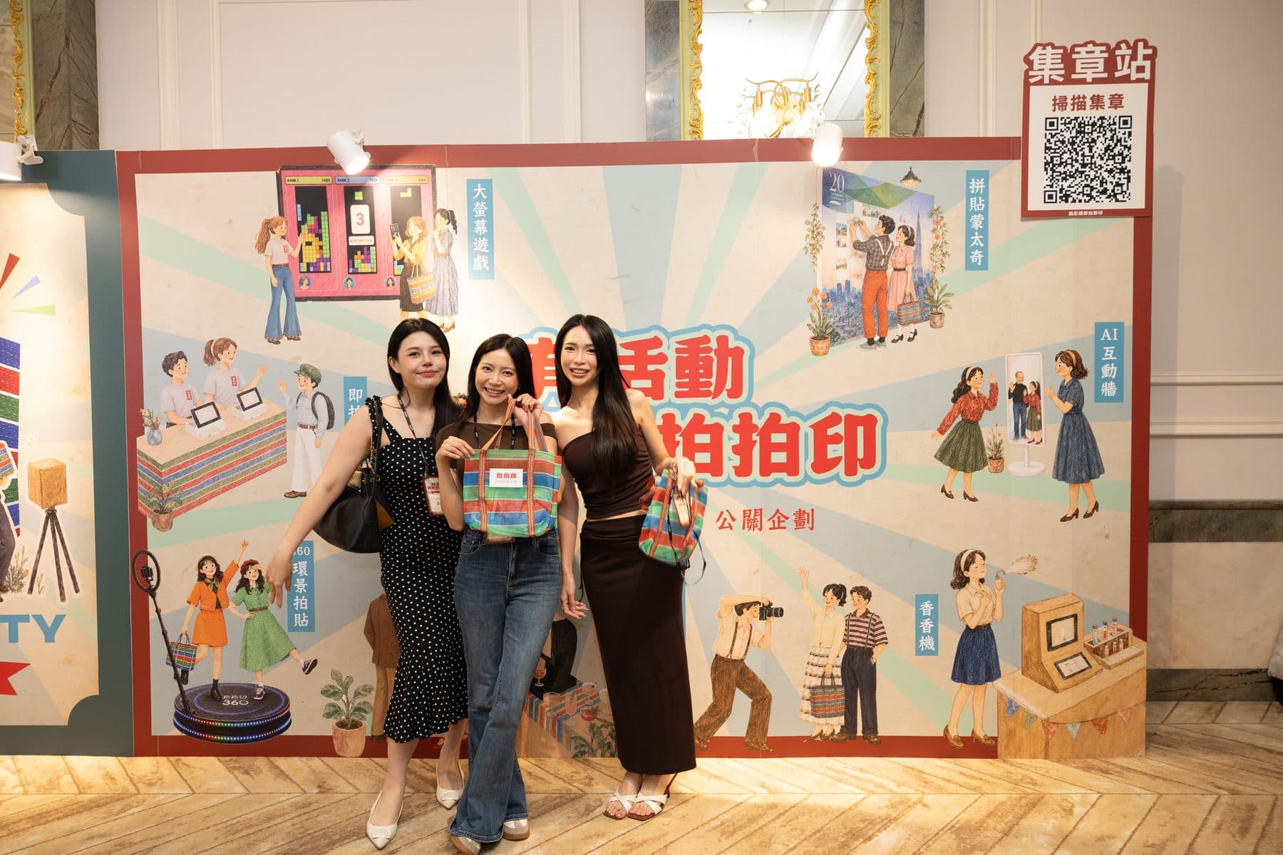 Three guests posing happily at the backdrop that carries the stamp-station QR code, holding event totes