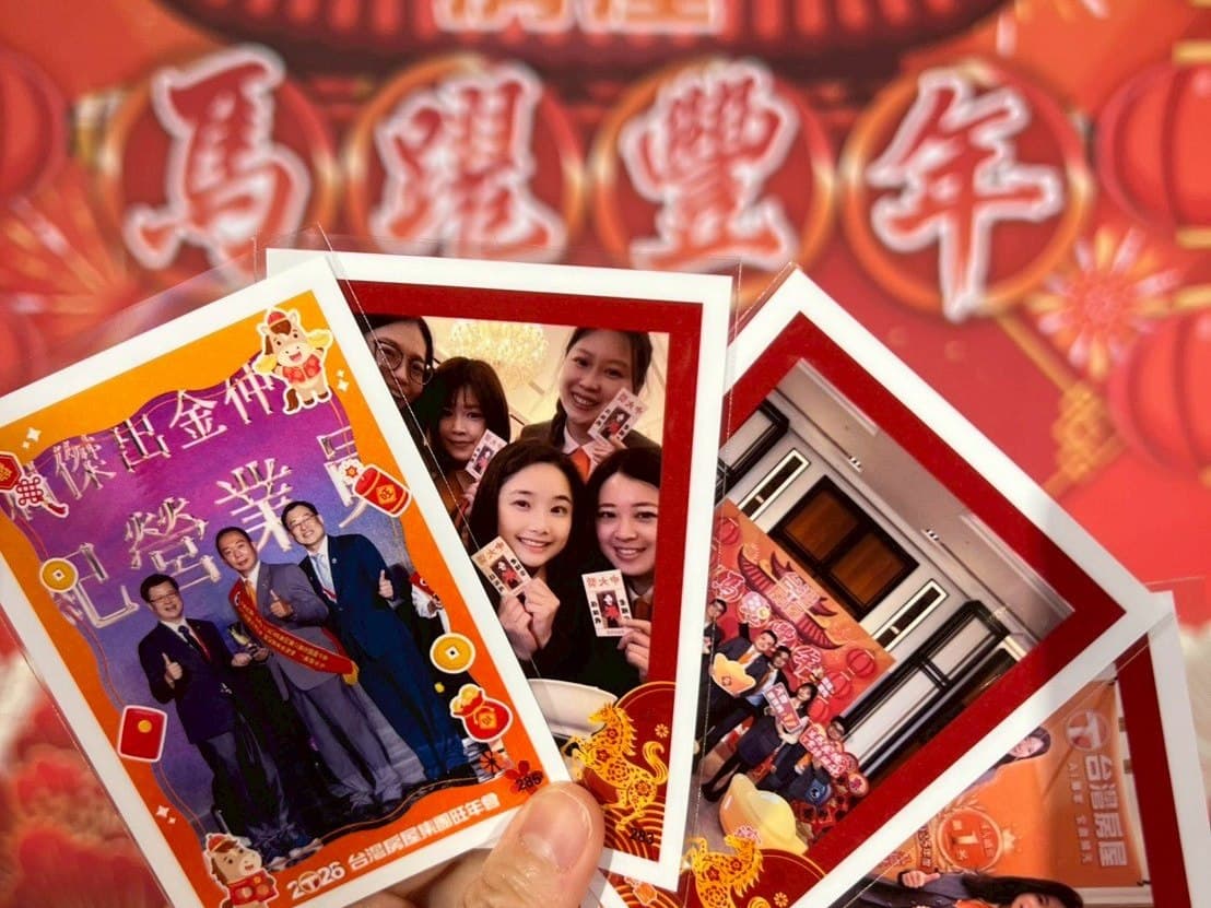A hand fans five prints in front of a red spring-party backdrop, all sharing one custom frame design